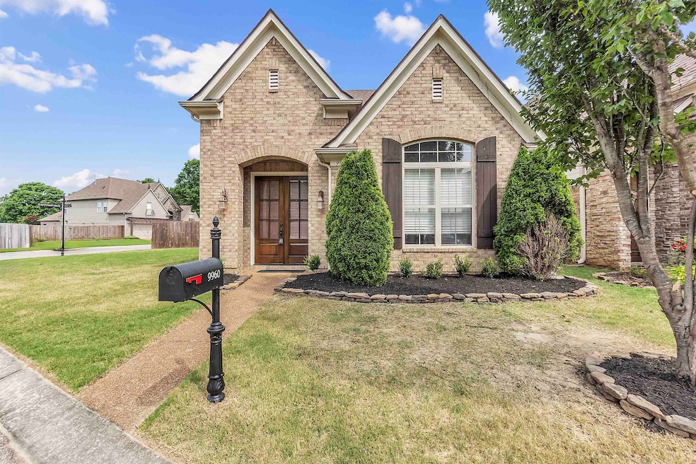French country style house featuring brick siding and french doors