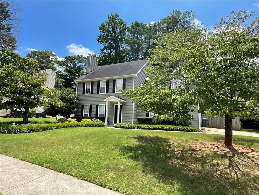 Colonial-style house featuring a front yard