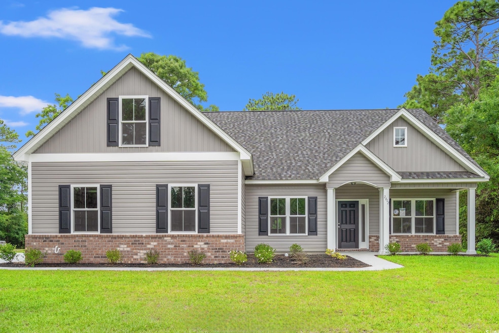 Craftsman house featuring brick siding, a front yard, and a shingled roof