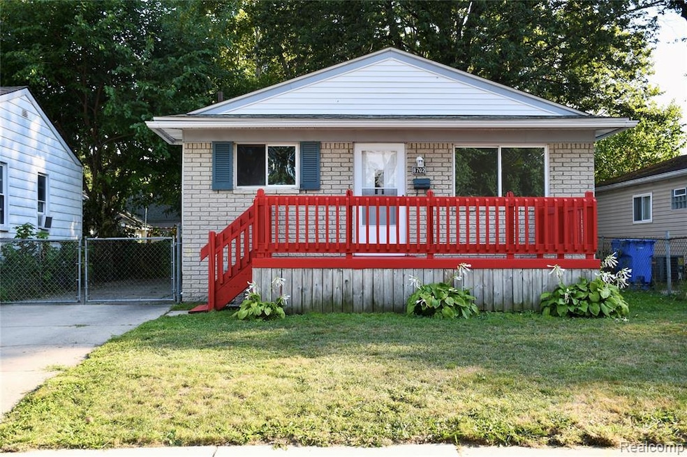 View of front of property featuring brick siding and a deck