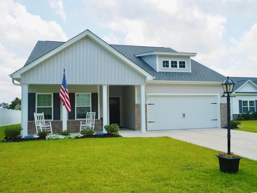 Craftsman-style home with a garage, a front yard, 