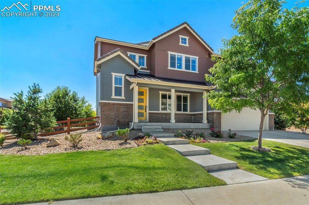 View of front of home featuring a porch, a garage,