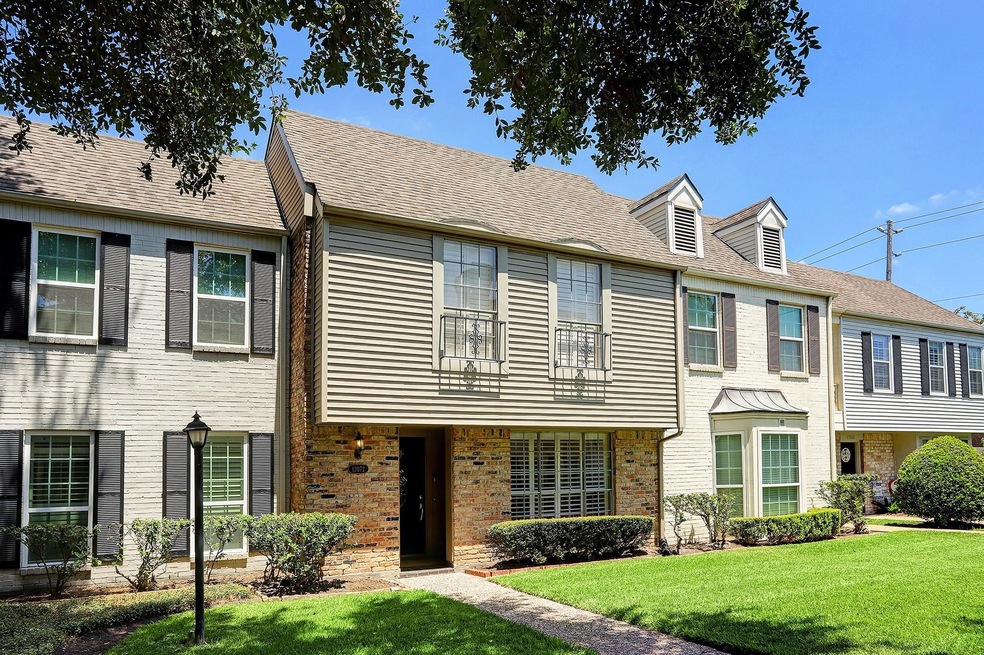 A welcoming exterior featuring a classic brick faç