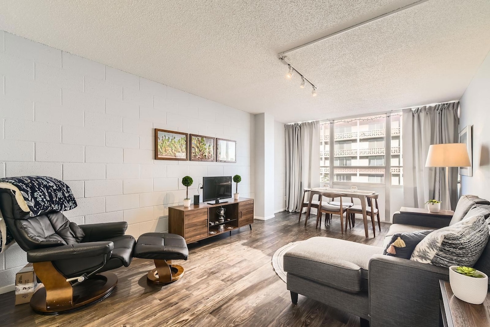 Living area featuring wood finished floors, a tex
