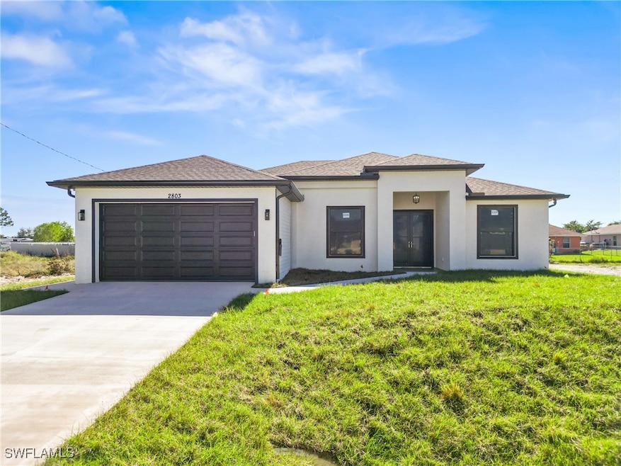 View of front facade with a garage and a front yar