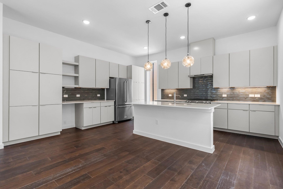 Kitchen with high end refrigerator, open shelves,