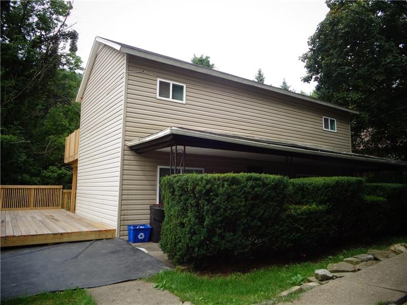 FRONT OF THE HOME WITH HIDDEN FRONT PORCH AND ACCE
