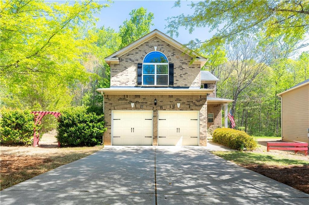 View of front of property featuring concrete drive