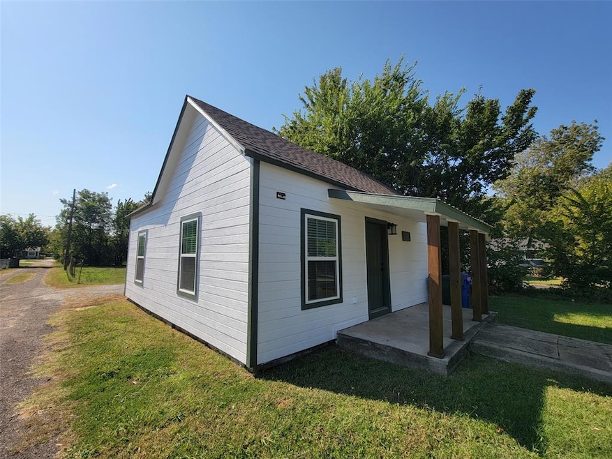 View of side of property with a lawn
