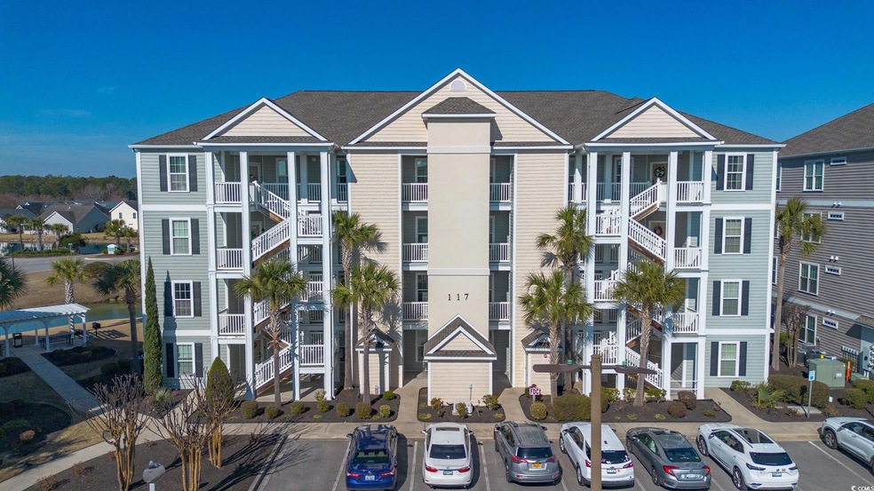 View of property featuring uncovered parking