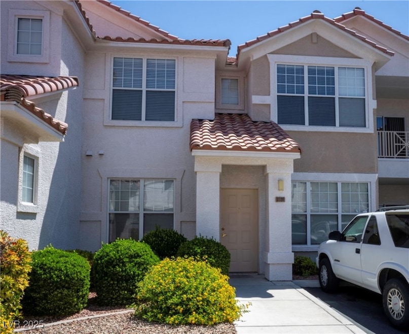 Multi unit property featuring a tile roof and stuc