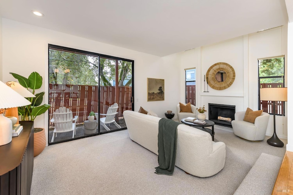 Living room with vaulted ceiling, fireplace and outdoor patio