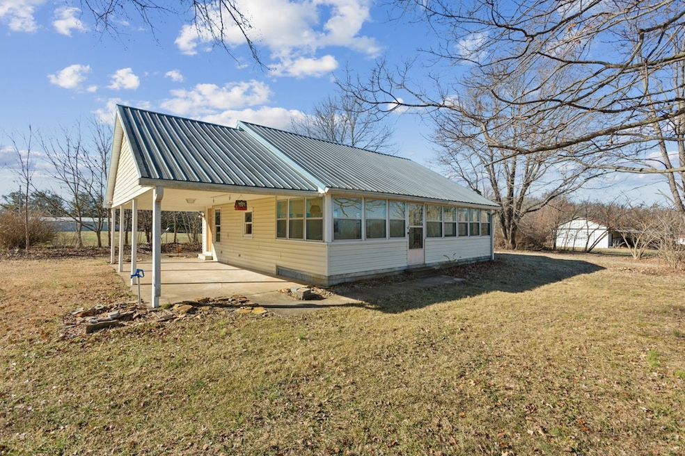 This lovely cottage on 4 ac offers 2 covered porches. Side enclosed sun porch and a covered front patio porch. The metal barn you see is 39' x 23' belongs with this home.