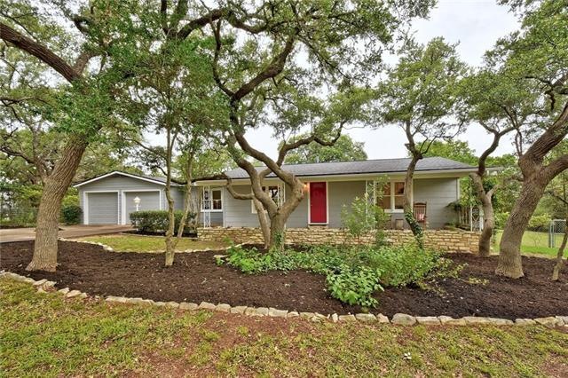 Main house set back from street nestled in the oaks.