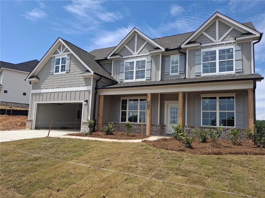 Craftsman inspired home with board and batten siding, an attached garage, driveway, and a front yard