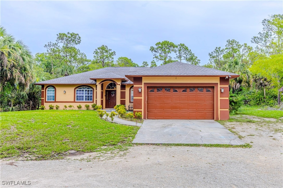 Ranch-style house with concrete driveway, stucco s