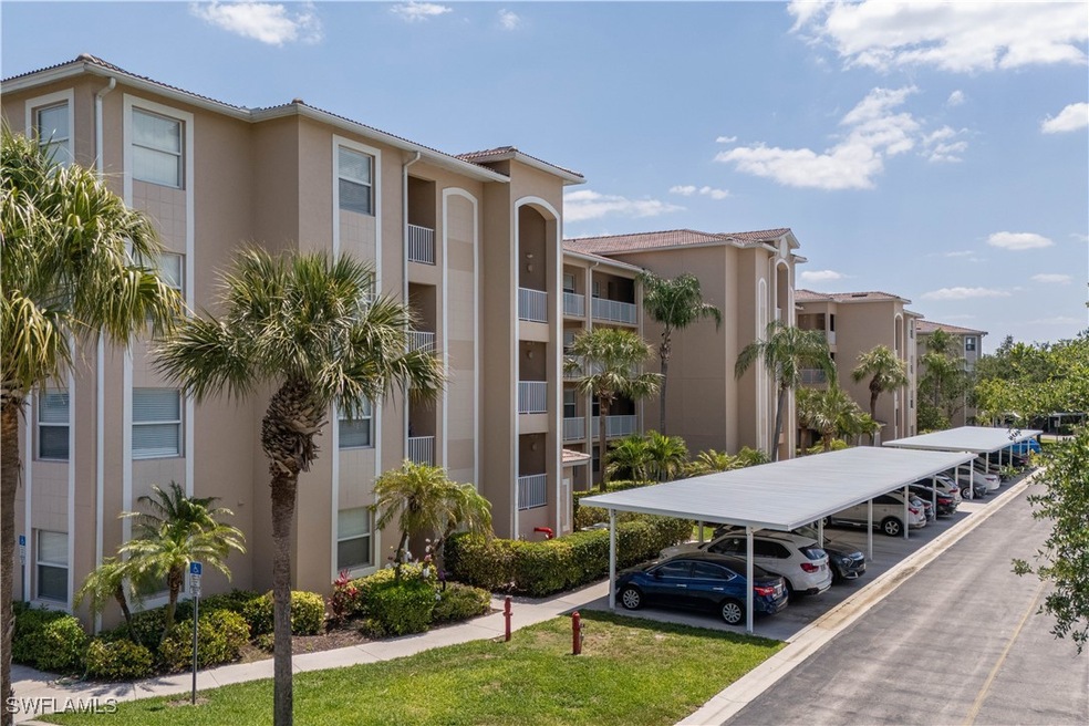 View of property featuring covered parking