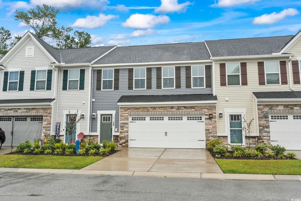Townhome / multi-family property featuring a garag