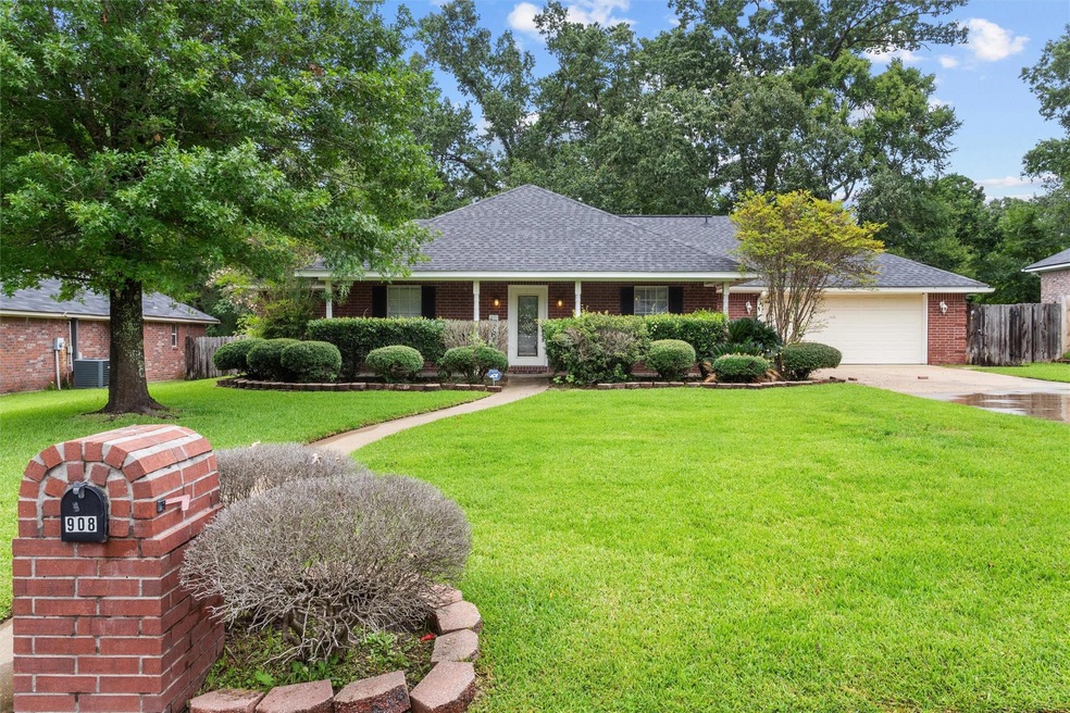 Ranch-style home featuring a garage and a front lawn