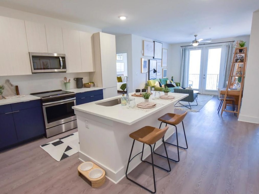 Kitchen featuring light wood-type flooring, white 
