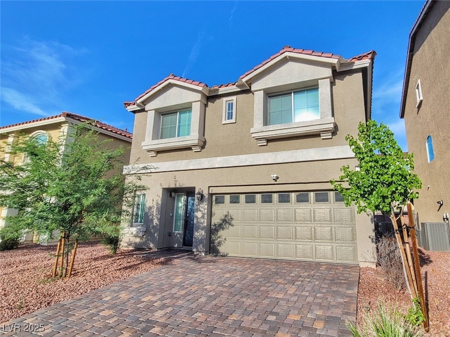 View of front of home with a tiled roof, stucco si