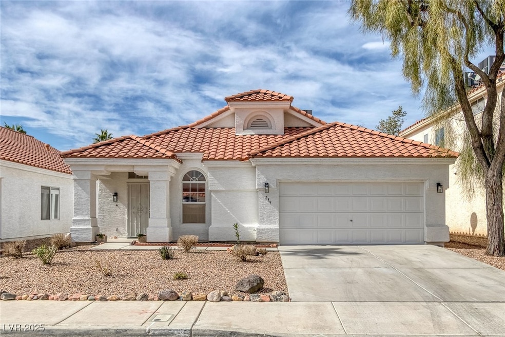 Mediterranean / spanish house with a garage, drive