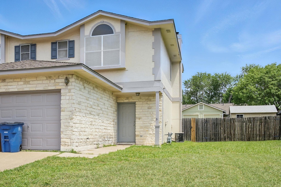 View of front of home with stucco siding, a garag