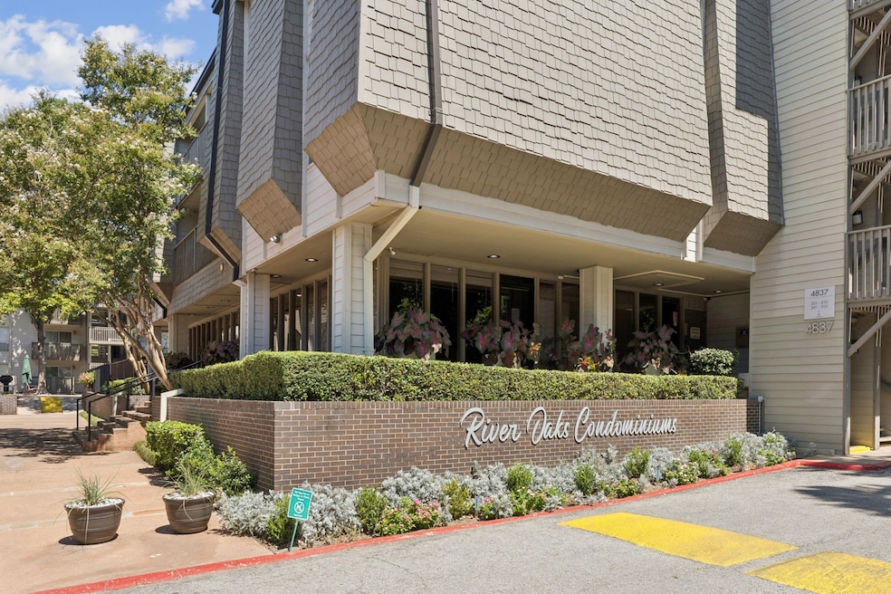 Welcome to River Oaks Condominiums, a beautifully maintained community with lush landscaping, mature trees, and a modern mid-rise vibe. The well-manicured entry sets the tone for comfortable and stylish living.