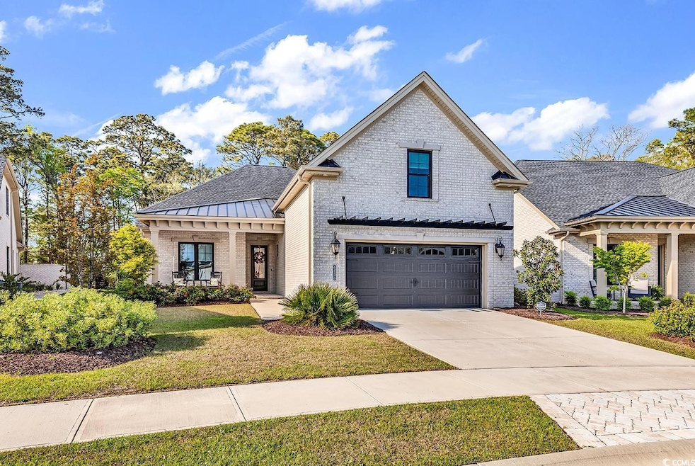 Modern farmhouse featuring driveway, an attached g
