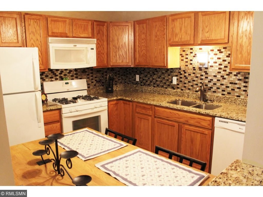 Gorgeous kitchen with granite counters and glass b
