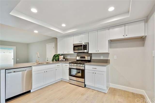 Remodeled kitchen with white shaker style cabinets