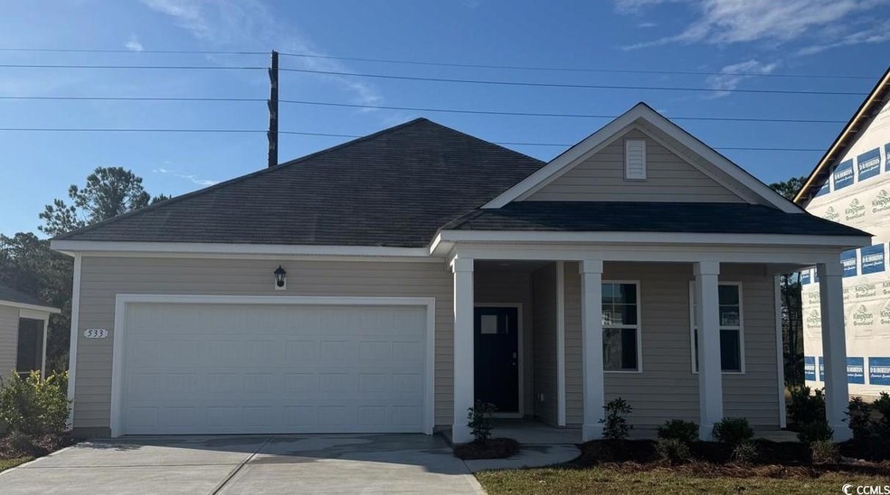 View of front of house with a garage, roof with sh