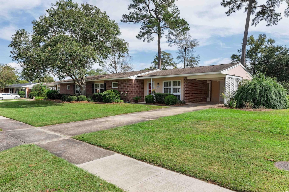 Ranch-style house with a front yard and a carport