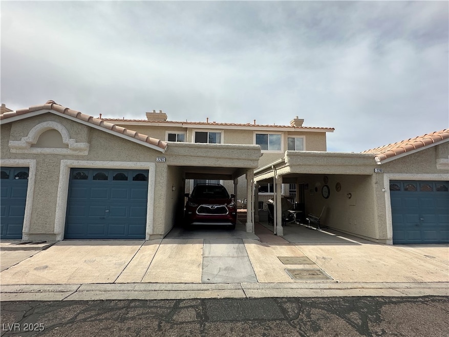 View of front of home with a carport, a tiled roof