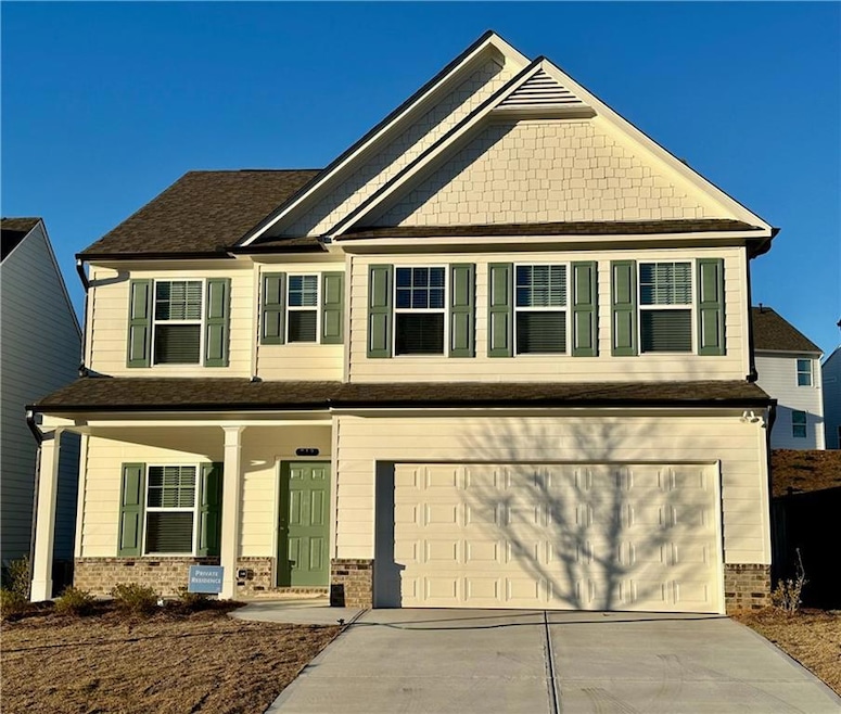 Craftsman house featuring brick siding, covered porch, concrete driveway, a shingled roof, and an attached garage