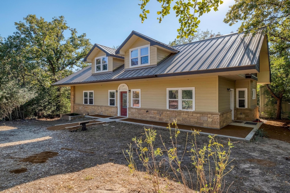 View of front of property featuring stone siding,