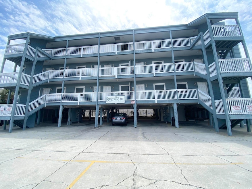 View of property featuring covered parking