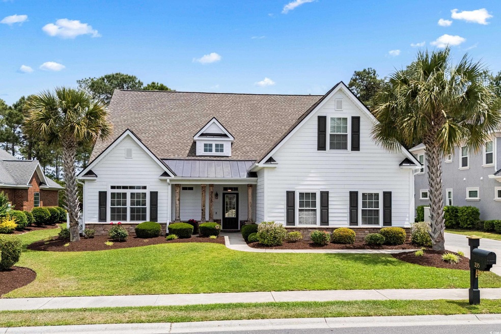 View of front of house with a front lawn, a standi