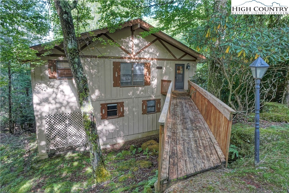 Classic chalet nestled in the woods with rushing c