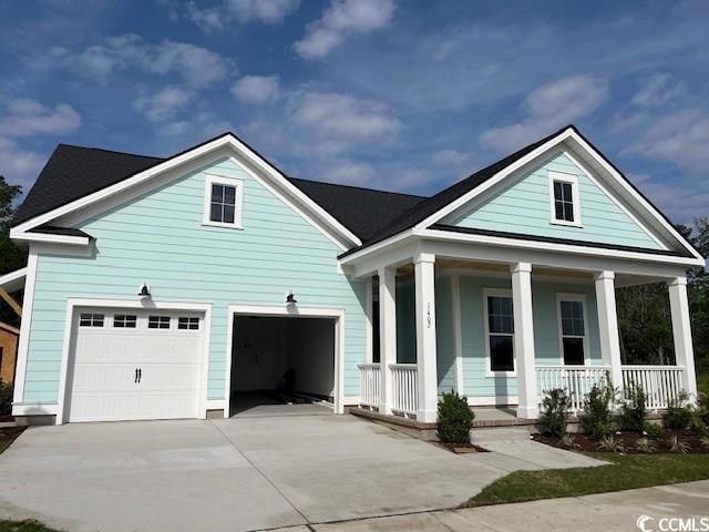 View of front of home with a garage, concrete driv