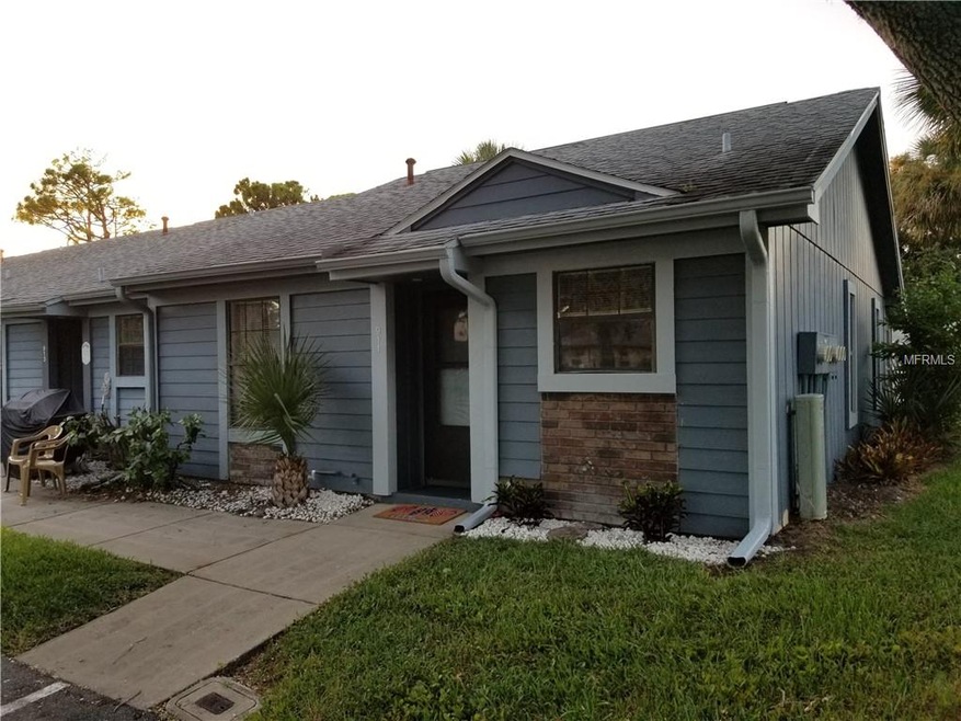 Adorable end unit with well-kept landscaping.