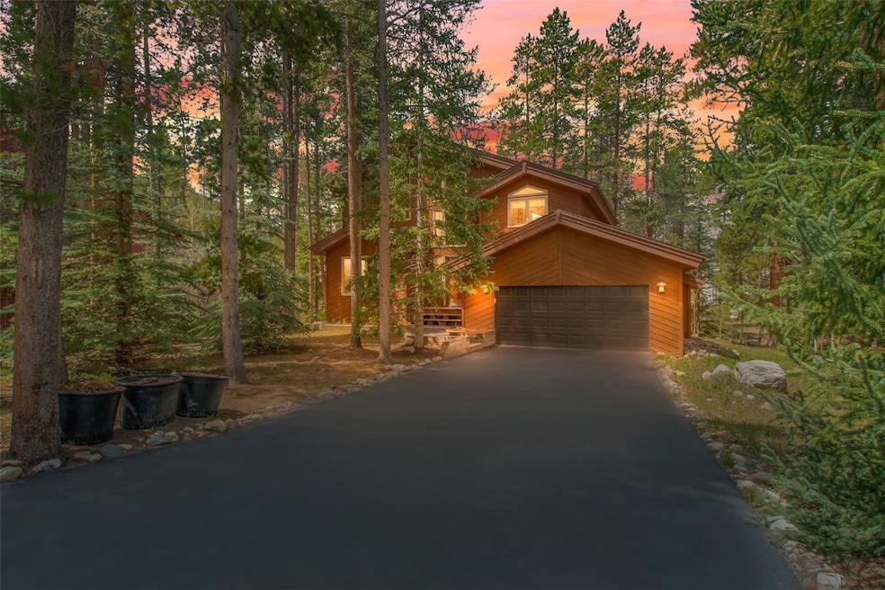 View of front of house with driveway and an attach