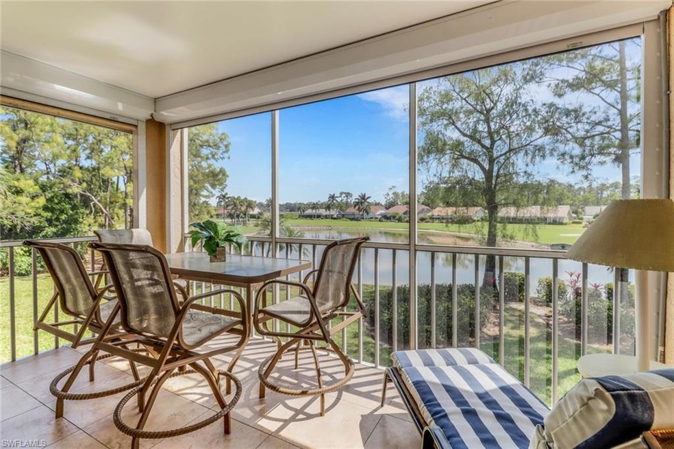 Sunroom with tile patterned floors and a water vie