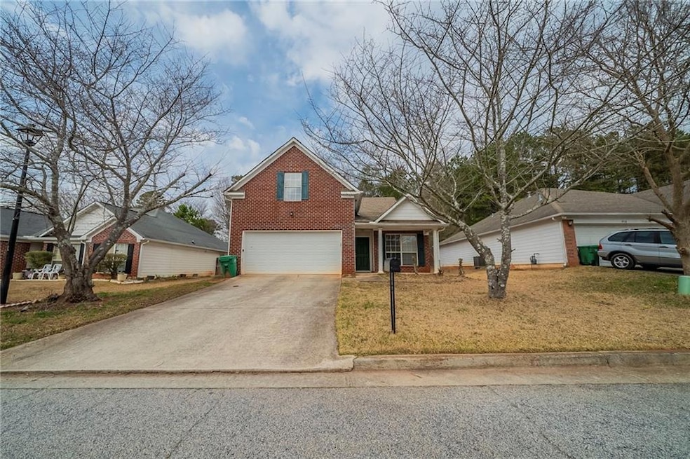 Traditional-style house featuring a garage, drivew