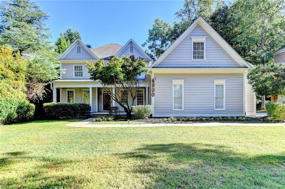 View of front of home featuring a front lawn and c