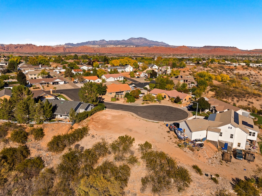Aerial view of property's location with mountains and nearby suburban area