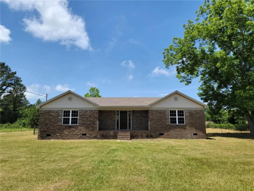 Single story home featuring crawl space, brick siding, and a front lawn