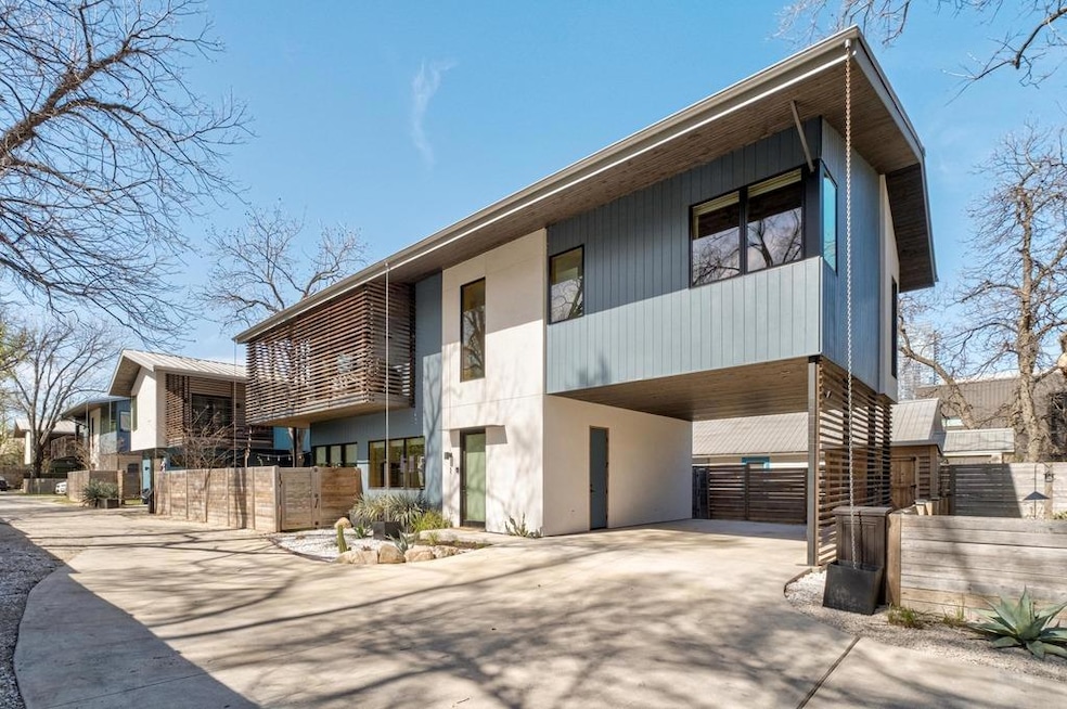 View of property featuring fence, concrete drivew