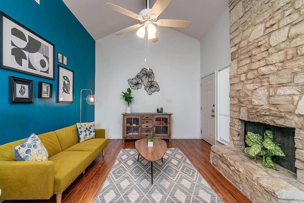 Living room with baseboards, a fireplace, ceiling