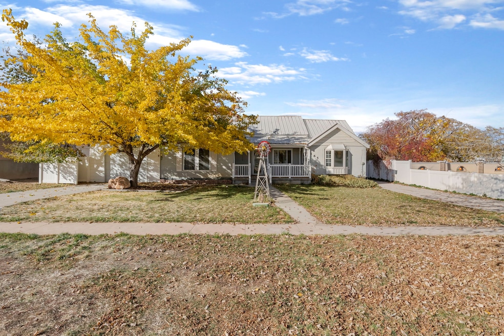 View of front of property featuring a porch and a metal roof